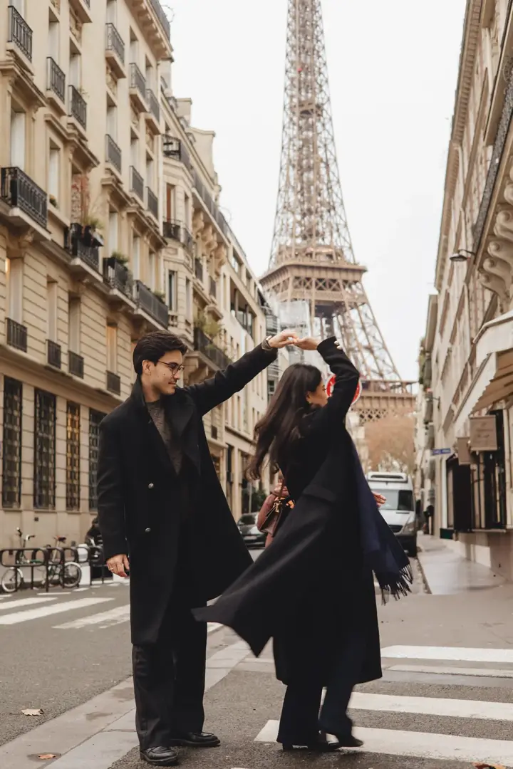 Couple dancing spinning Paris street Eiffel Tower