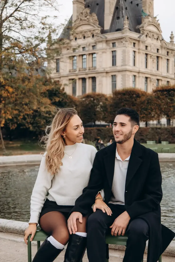 Couple sitting Tuileries fountain bench blonde autumn Paris